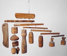 an assortment of wooden objects hanging from strings