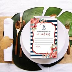 a white plate topped with a card next to a fork and knife on top of a table