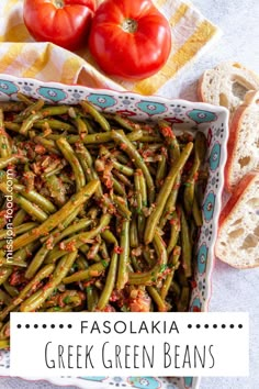 green beans in a dish with tomatoes and bread on the side