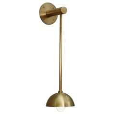 a brass colored light fixture on a white background with no one in the room to see it