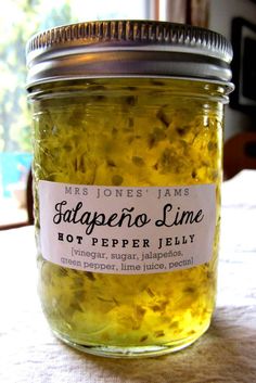 a jar filled with yellow flowers sitting on top of a table