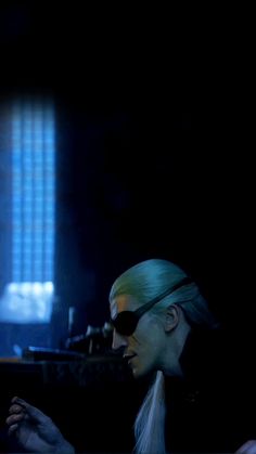 a woman with green hair and sunglasses is looking at her cell phone in the dark