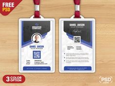 two id cards with red and blue lanyards are on a wooden surface, one is