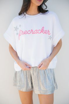 The "SHE'S A FIRECRACKER WHITE TEE" is perfect for any event. This oversized WHITE tee is perfect for everyday wear. Whether you're popping fireworks, by the pool, or just dreaming of summer, let everyone know that you're the life of the party. Match with your mini with the Mini Kid's Lil Firecracker tee! All orders are currently shipping within 14 business days. To receive item quicker, expedited shipping is available at checkout. Trendy Graphic Print T-shirt For 4th Of July, White Crew Neck T-shirt For 4th Of July, Fun 4th Of July Graphic Print T-shirt, 4th Of July White T-shirt With Text Print, Playful White T-shirt For 4th Of July, Everyone Knows, Everyday Wear, White, How To Wear