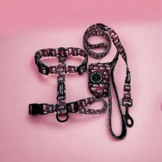 two leashes on a pink background one has a black and white pattern