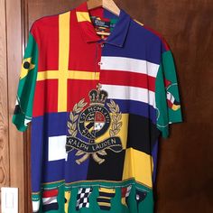 Polo Crest Shirt In Excellent Condition. Worn Only Once Designer Short Sleeve Multicolor Shirt, Designer Multicolor Graphic Print Tops, Designer Multicolor Print Summer Tops, Designer Multicolor Print Tops For Summer, Multicolor Polo Collar Top With Graphic Print, Multicolor Graphic Print Polo Collar Top, Multicolor Graphic Print Top With Polo Collar, Multicolor Graphic Print Short Sleeve Polo Shirt, Designer Multicolor Collared Tops