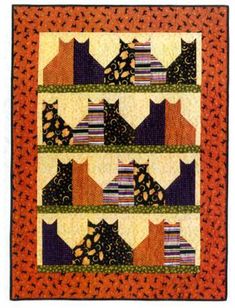 an orange and black quilt with cats on it