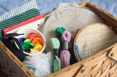 a basket filled with lots of craft supplies