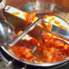 the food is being cooked in the pot on the stove top and ready to be eaten