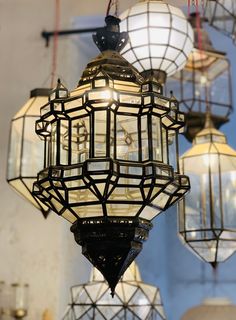 several lamps hanging from the ceiling in a room