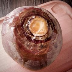 a glass vase sitting on top of a wooden table