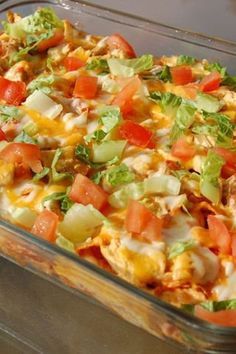 a glass casserole dish filled with vegetables and meat, sitting on a table