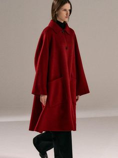 This luxurious single-breasted coat crafted from 100% wool offers superior insulation and beautiful draping in a striking red or black colorway. The feminine A-line silhouette is enhanced with thoughtful details including natural horn buttons, front pockets, and a center back vent, all fully lined in twill. Perfect for elevating any outfit from casual denim to formal wear, this handmade piece represents the perfect marriage of timeless elegance and versatile styling.Color: Red, Black Colorful Wool Coat, Red Peacoat, Red Or Black, Wool Coats, Single Breasted Coat, Perfect Marriage, Red Coat, Casual Denim, Wool Coat