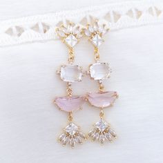 Wear this exquisite pink statement earrings to your wedding or any formal event and channel the glamorous art deco era. This art deco feature a unique arrangement of clear and light pink crystals that catch and reflect light from every angle, creating a mesmerizing play of shimmer and sparkle.The secure push back closure ensures that you can dance and mingle with confidence, knowing that your earrings will remain in place.✨Suggested occasion for wear: your wedding, wedding guest, bridal shower, Chic Sparkling Stones Jewelry For Wedding, Chic Wedding Jewelry With Sparkling Stones, Feminine Crystal Jewelry For Weddings, Pink Crystal Earrings For Pierced Ears, Elegant Pink Chandelier Earrings For Formal Occasions, Elegant Pink Chandelier Earrings For Formal Events, Chic Pink Earrings For Formal Occasions, Glamorous Pink Bridal Earrings For Wedding, Glamorous Pink Bridal Earrings