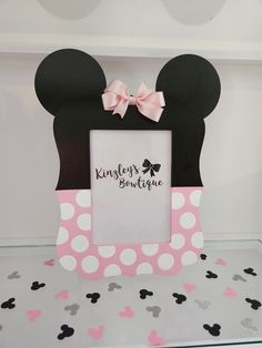 a minnie mouse photo frame with a pink bow