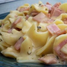 pasta with ham and cheese on a blue plate