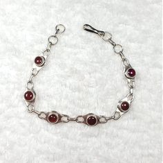 SALE! SALE! SALE  Bracelet details  Section: Silver bracelet Main stone: Red garnet Metal: Sterling Silver Length: 7 1/2 inches Width: 1/4 inch You can feel free to ask for any ring size Handmade in the USA Stamped  You can shop at: * Esty: www.etsy.com/shop/SandiaJewelryNM SandiaJewelryNM specializes in providing jewelry collections by handmade. We have special items and they are designed in various shapes and stones. We supply large quantities of Turquoise, Coral, and Opal Jewelry. Specially, we have many colors for every jewelry stone such as White Opal, Blue Opal, Pink Opal.  If you have any questions, please do not hesitate in contacting us. We are here to help and try to answer as soon as we can. Thank you for reading this whole description and looking at our shop. Please, have a gre Formal Adjustable Ruby Bracelets, Adjustable Ruby Bracelets For Formal Occasions, Adjustable Ruby Bracelet For Formal Occasions, Red Adjustable Beaded Bracelets For Formal Occasion, Red Adjustable Beaded Bracelets For Formal Wear, Handmade Adjustable Red Sterling Silver Bracelet, Handmade Red Ruby Bracelets, Red Metal Chain Bracelet Gift, Red Metal Chain Bracelet For Gift