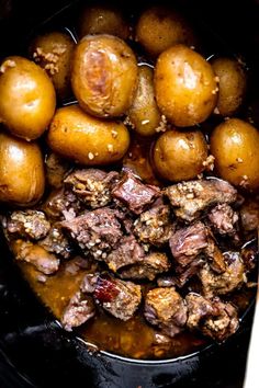 some meat and potatoes are cooking in the slow cooker for dinner or stewing