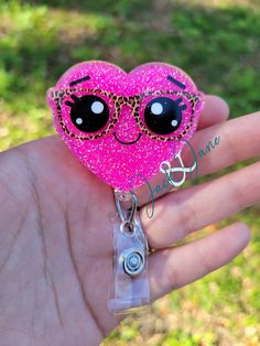 Glittered Heart with Leopard Glasses Acrylic Retractable Badge Reel! Great gift for nurses, doctors, teachers or anyone that wears a ID Badge! Perfect for Valentine's day! Available permanently attached to a stationary alligator, a 360o swivel alligator, or a slide-on clip. This hearts badge reel is made with an acrylic blank, glitter, vinyl, and resin. The Glitter is sealed in and will not come off. Measures approximately 2 inches on longest side Badge reels are made to order so please check estimated turnaround time BEFORE ordering. Contact me before ordering if you need by a certain date, and I will let you know if this can be accommodated. Please handle with care! They are sturdy, but may break if dropped or knocked against a hard surface just right. Wipe clean with a soft cloth or a w Trendy Pink Badge Holders As Gift, Pink Novelty Craft Supplies For Gifts, Novelty Pink Craft Supplies For Birthday, Pink Novelty Craft Supplies For Birthday, Pink Plastic Craft Supplies For Gifts, Adjustable Novelty Pink Badge Holders, Customizable Fun Badge Reel For Gifts, Personalized Badge Reel For Valentine's Day Gift, Cute Personalized Badge Reel For Gifts