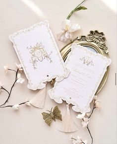 the wedding stationery is laid out on top of the table with flowers and butterflies