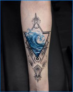 a man's arm with a blue wave and triangle tattoo design on the forearm