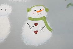 a painted snowman with hearts on it's nose