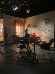 a camera set up in the middle of a room with chairs and lights on it