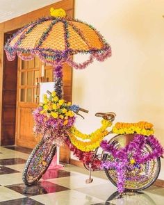 a bicycle decorated with flowers and an umbrella