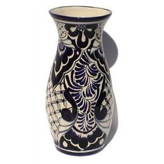 a black and white vase sitting on top of a table