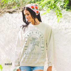 "Outlander Fans! Embrace your love of the Outlander series in this Dame Blanche Outlander Sweatshirt, inspired by Clair and her tender healing talents. Fans of Outlander series or Outlander books will adore this cozy bookish crewneck. It makes the perfect gift for any reader, Diana Gabaldon fan, or fans of the Outlander series. 🍀 Available colors: WHITE, SAND, MILITARY GREEN, FOREST GREEN, LIGHT BLUE, NAVY, BLOSSOM, AND BLACK. Other colors available upon request. Please message me for custom orders. 🍀 For more bookish merch, be sure to check out the other products in my store: https://printsnpauper.etsy.com 🍀 Don't forget to \"Follow Shop\" to stay up-to-date on new products and sales. About your new sweatshirt: 🍁 Quality 🍁 Comfort🍁 Durability 🍁 Made using 100% Cotton for 🍁 Unmatch Outlander Lallybroch, Outlander T Shirts, Outlander Merchandise, To Bed Or To Sleep Outlander, Outlander Gifts, Outlander Sport, Outlander Book, Outlander Fan, Diana Gabaldon