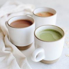 two cups of green tea on a white cloth