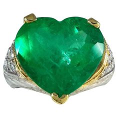 18K Two-Tone Heart-Shape Emerald Diamond Ring! Indulge in the allure of our exquisite 18K Two-Tone Heart-Shape Emerald Diamond Ring, a perfect fusion of sophistication and timeless elegance. Ring Highlights: Metal: 18K Two-Tone Gold - A harmonious blend of white and yellow gold Gemstone: Heart-Shape Emerald - The symbol of rebirth and eternal love Diamonds: Surrounding the emerald for added brilliance Design: A unique and enchanting heart-shape setting Why Choose Our Emerald Diamond Ring? Timele Colombian Emerald Ring, Contemporary Engagement Rings, Fancy Yellow Diamond, Modern Engagement Rings, Emerald Diamond Ring, Family Jewellery, Jewels Rings, Colombian Emeralds, 18k Gold Ring