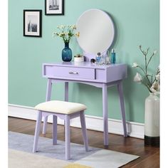 a purple vanity table with a mirror and stool