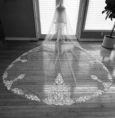 a bridal veil on the floor in front of a window