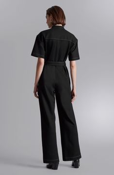 Contrast stitching amplifies the utilitarian vibes of a wide-leg jumpsuit tied with a matching belt. 30" inseam, 20" leg opening, 56" length (size Small) Front button closure Band collar Short sleeves Front patch pockets; side-seam pockets Removable tie belt 73% viscose, 23% polyamide, 4% elastane Dry clean Imported Utility Overalls With Belt Loops For Workwear, Short Sleeve Denim Utility Jumpsuit For Workwear, Utility Style Denim Jumpsuit With Short Sleeves For Work, Workwear Jumpsuits And Rompers With Belt Loops, Black Utility Overalls Romper, Black Utility Overall Jumpsuits And Rompers, Black Utility Overall Jumpsuits, Black Utility Overalls Jumpsuit, Black Relaxed Fit Jumpsuit For Workwear