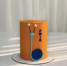 an orange and blue cake with the words amr on it