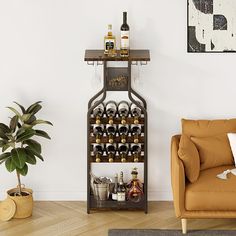 a living room filled with furniture and a wine rack next to a couch on top of a hard wood floor