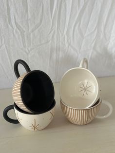 three bowls and one bowl are stacked on top of each other with black lids,