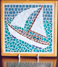 a mosaic tile with a sailboat on it