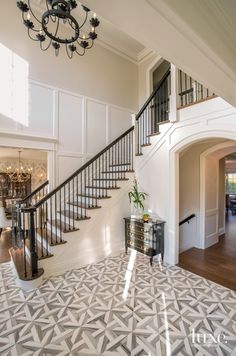 a staircase in a home with white walls and wood floors