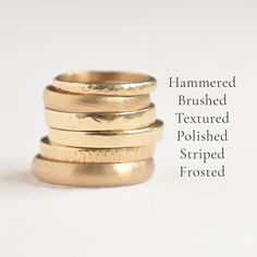 four gold rings stacked on top of each other with the words hammered brushed textured polished