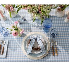 a blue and white table setting with flowers