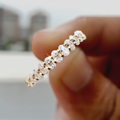 a close up of a person holding a diamond ring