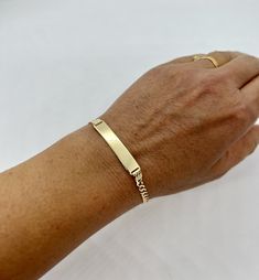 "10k SOLID GOLD WOMEN'S Cuban link ID BRACELET  width: 3.5mm  choice of length: 7\", 8\"  These bracelets are made with 10K gold in a Cuban link style. Cuban bracelets are specially known for their shine and strength. The bracelets have a lobster lock.  The ID bracelet is 6.5mm x 30.6mm. The bracelet links are 3.5mm in width. The approximate weight of the 8\" bracelet is 5.1 grams. The bracelets are marked 10k for metal authenticity. Now offered at an unbeatable price.  Very solid Free Laser eng Classic 14k Gold Personalized Chain Bracelet, Classic Personalized 14k Gold Chain Bracelet, Classic Name Bracelet With Curb Chain As A Gift, Classic Yellow Gold Rectangular Name Bracelet, Classic Gold Name Bracelet With Curb Chain, Classic Gold Bracelet With Name For Anniversary, Classic Gold Name Bracelet For Anniversary, Classic Gold Name Bracelet, Classic Rectangular Name Bracelet, Tarnish Resistant