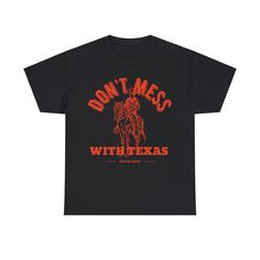 Introducing our "Don't Mess With Texas" Graphic Tee, a timeless tribute to the Lone Star State's spirit and pride. Crafted with premium, ultra-soft cotton and designed with a distressed graphicaesthetic, this tee captures the rugged charm and indomitable attitude of Texas. Featuring the iconic "Don't Mess With Texas" slogan emblazoned across the chest in bold, weathered lettering, this tee is a nod to the state's fierce independence and resilience. Whether you're a born-and-bred Texan or simply Cotton Slogan T-shirt Fan Apparel, Cotton Fan Apparel T-shirt With Slogan, Cotton Slogan T-shirt For Fan Apparel, Cotton Slogan T-shirt For Fans, Unisex T-shirt With Text Print For Fan Merchandise, Unisex Letter Print T-shirt Fan Merchandise, Unisex Letter Print T-shirt For Fans, Grunge Shirt With Letter Print For Fan Merchandise, Grunge Style Shirt With Letter Print For Fans