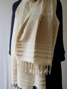 A hundred percent Eri Silk Stole that can also be used as a Dupatta to complement your Indian Ethnic suits.  The motifs are woven in Muga Spun Yarns. The motifs are typical of the region and are widely used in the traditional wear.  Since Eri Silk is there, the stole / dupatta does not have the typical sheen that is associated with Silks from India. Both Muga Silk and Eri Silk are indigenous Silk varieties from India found in Assam and some other North Eastern States. Eri Silk is the original As Traditional White Handloom Shawl, Beige Bohemian Dupatta With Traditional Patterns, Bohemian Beige Dupatta For Festivals, Beige Dupatta With Traditional Patterns, Beige Bohemian Dupatta For Festivals, Beige Traditional Shawl With Traditional Patterns, Traditional Beige Pashmina Shawl, Traditional Beige Dupatta With Patterns, Traditional Beige Dupatta With Traditional Patterns