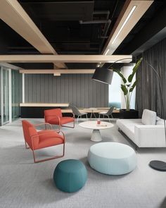 a living room filled with lots of white furniture and colorful pillows on top of it