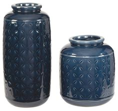 two blue vases sitting next to each other on a white background, one is empty