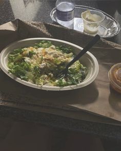 a white bowl filled with food on top of a table