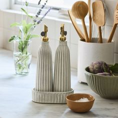 two salt and pepper shakers on a kitchen counter